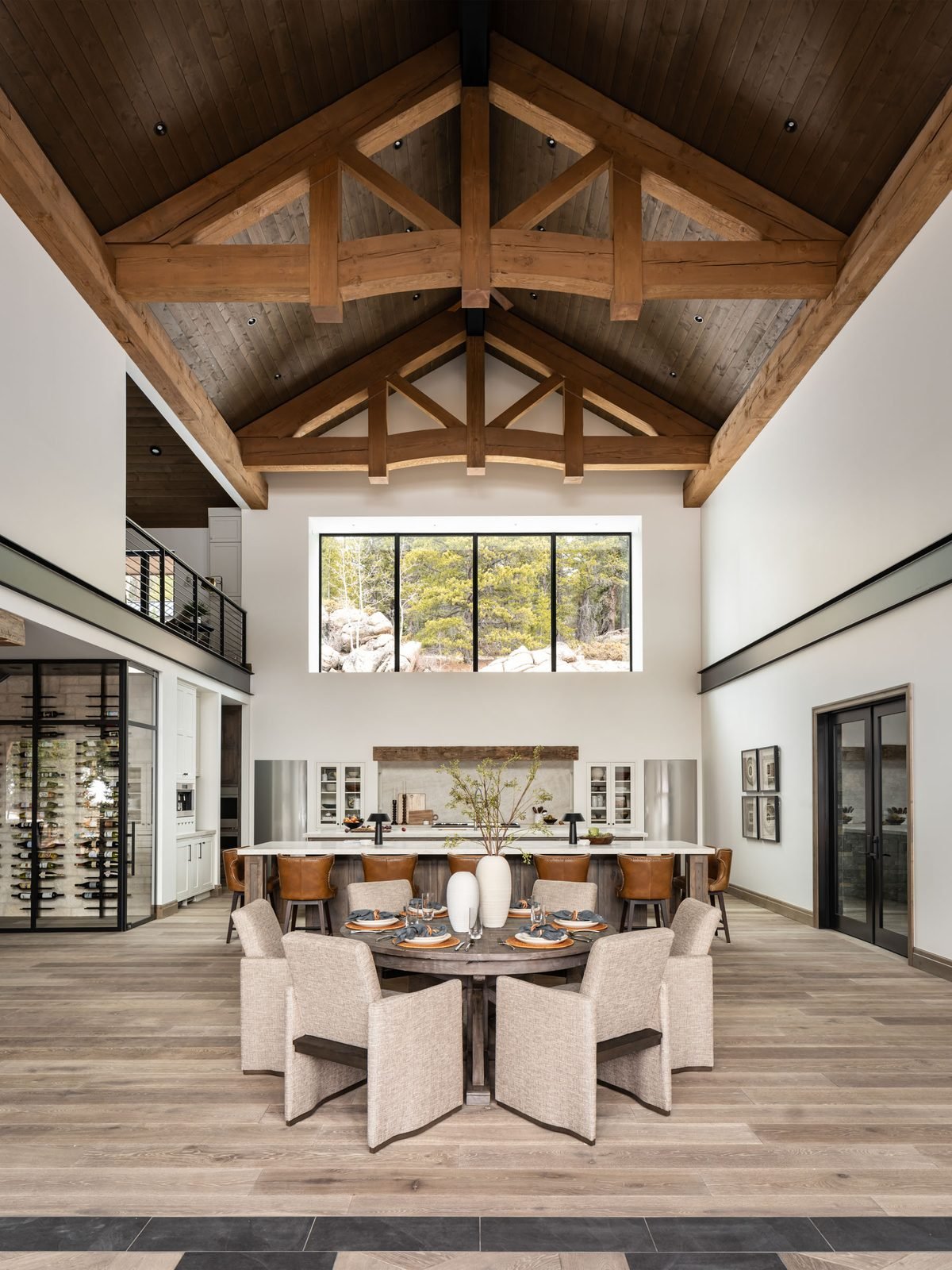 Great room seating area with stone fireplace and long dining table