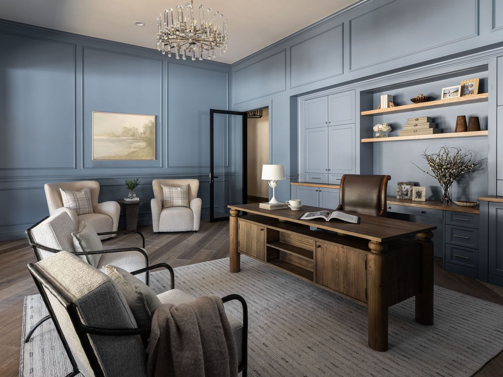 Home office with slate-blue paneling and chandelier