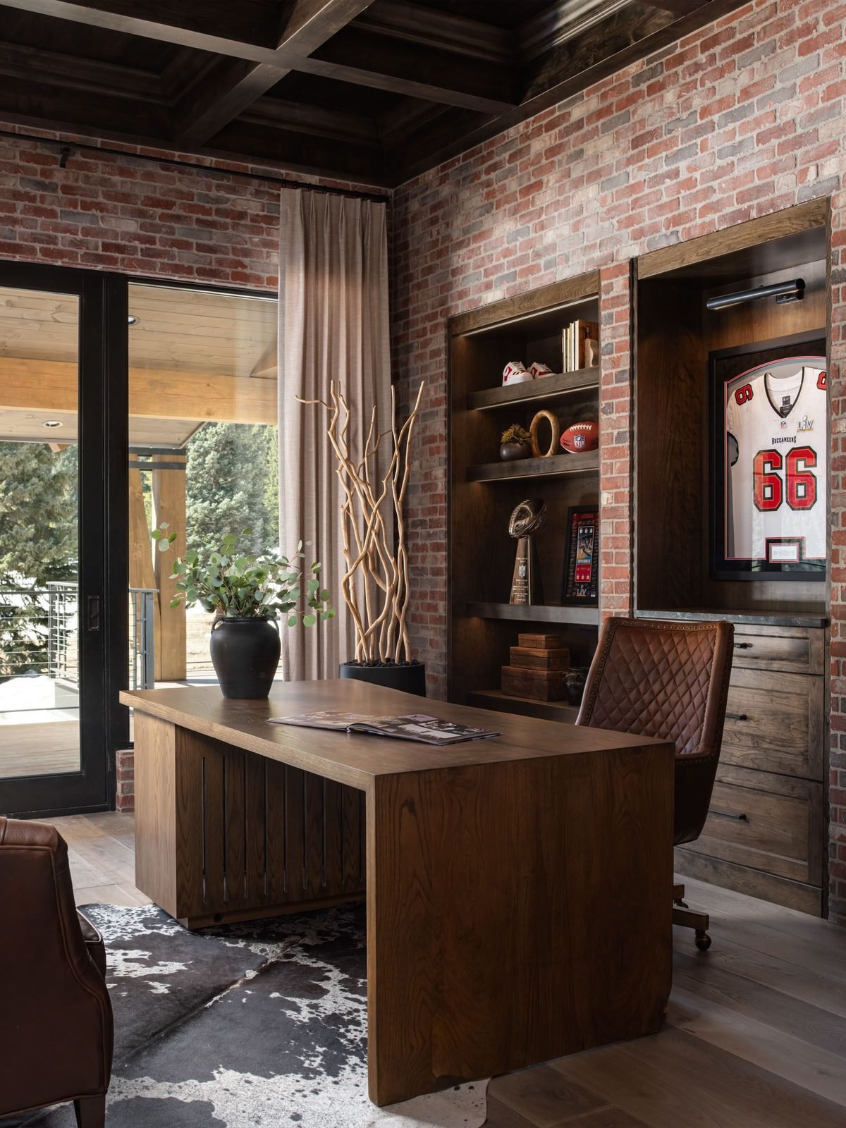 Office with exposed brick wall and built-in desk