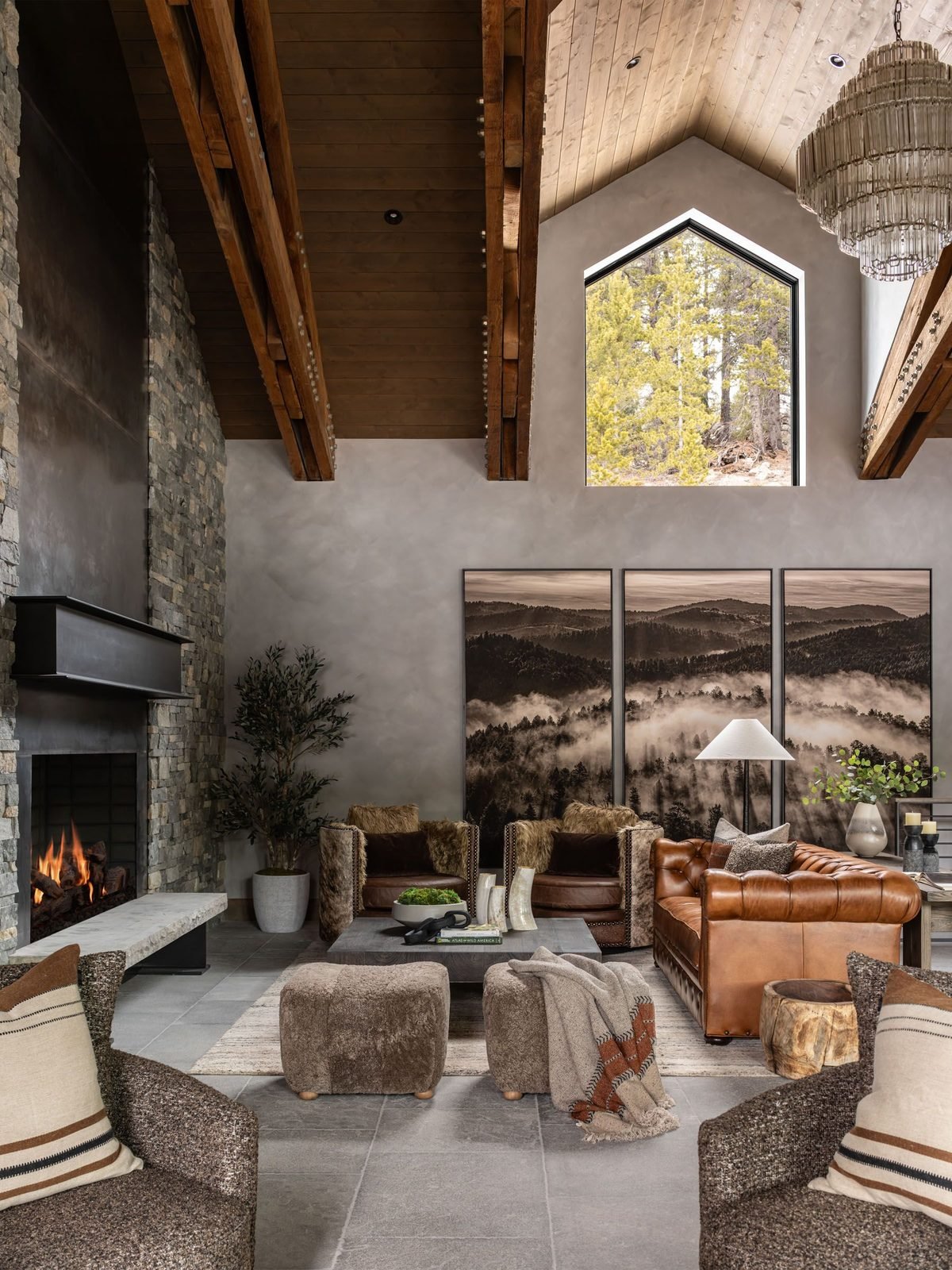 Great room with leather chesterfield sofa and mountain photography
