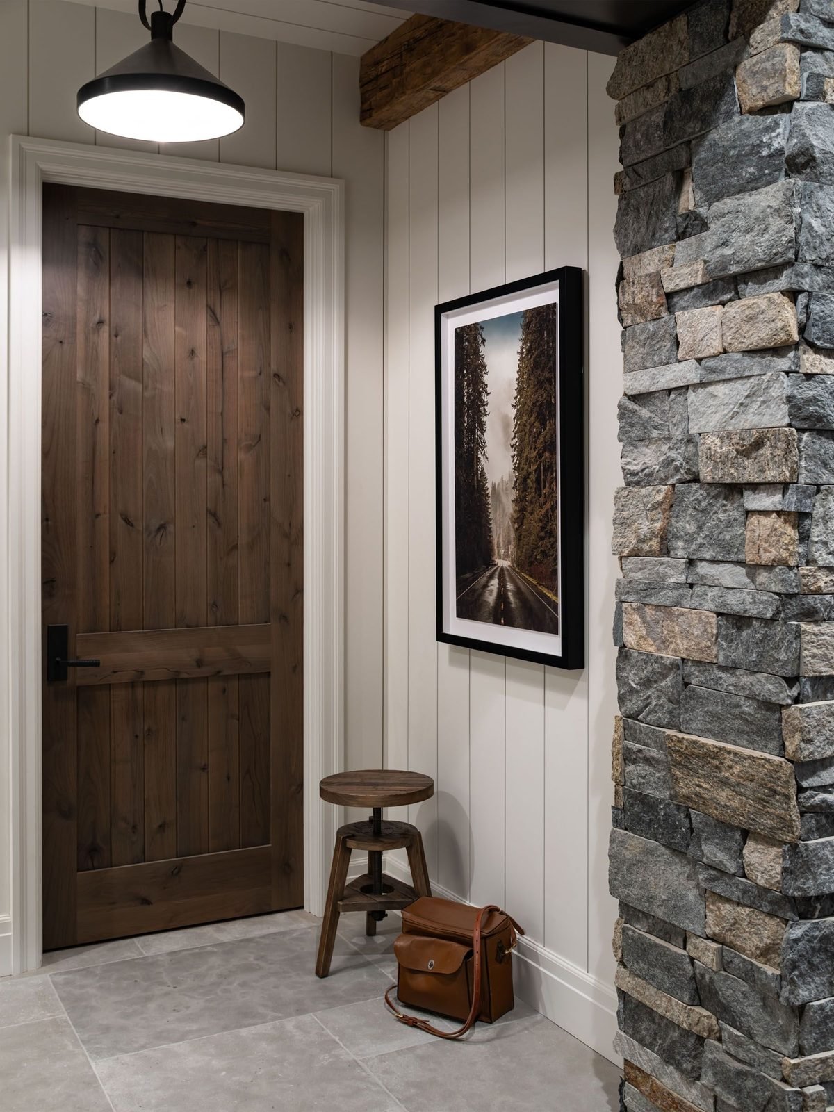 Mudroom entry with stool and framed print