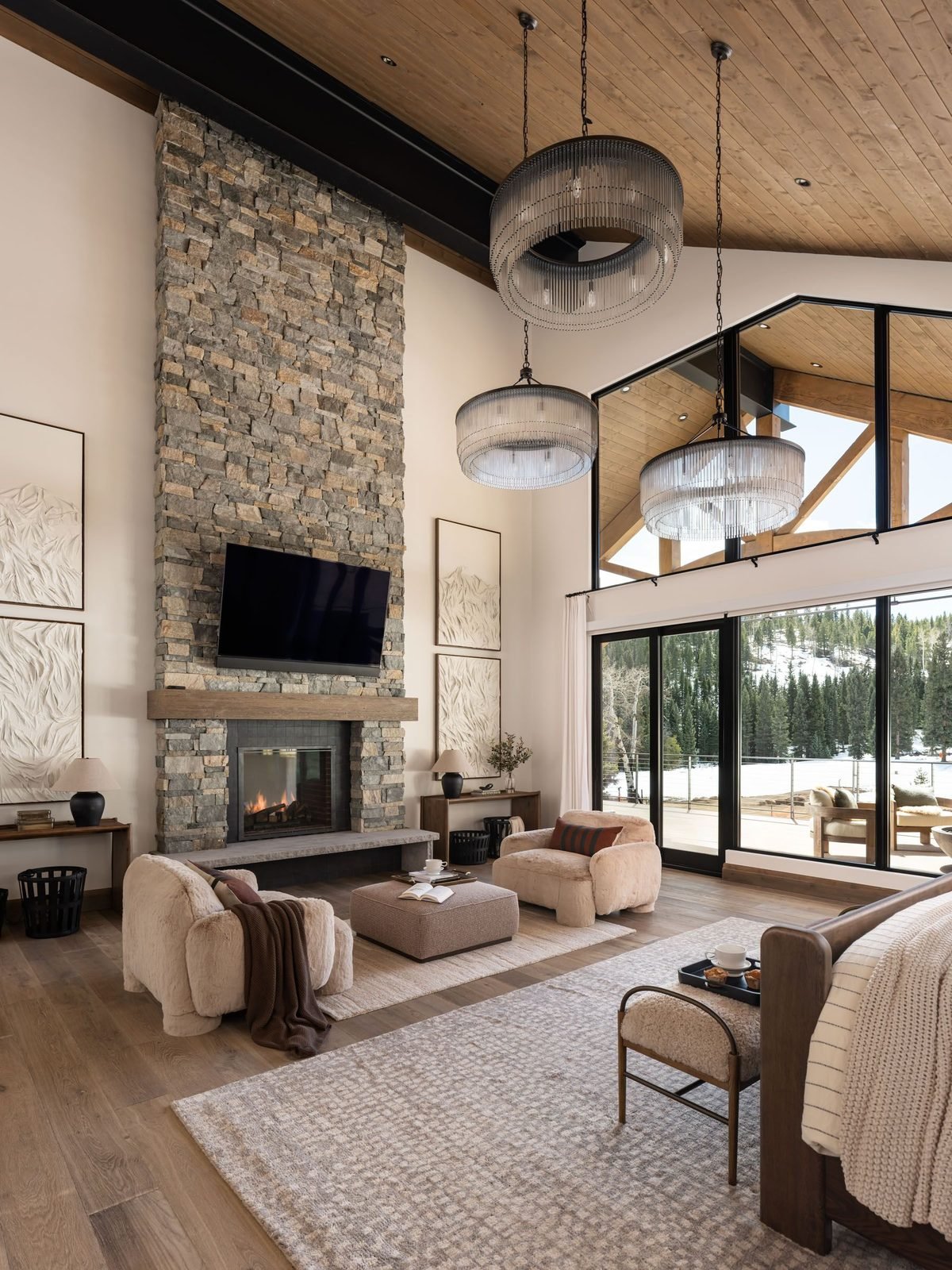 Primary bedroom with vaulted timber ceiling and stone fireplace