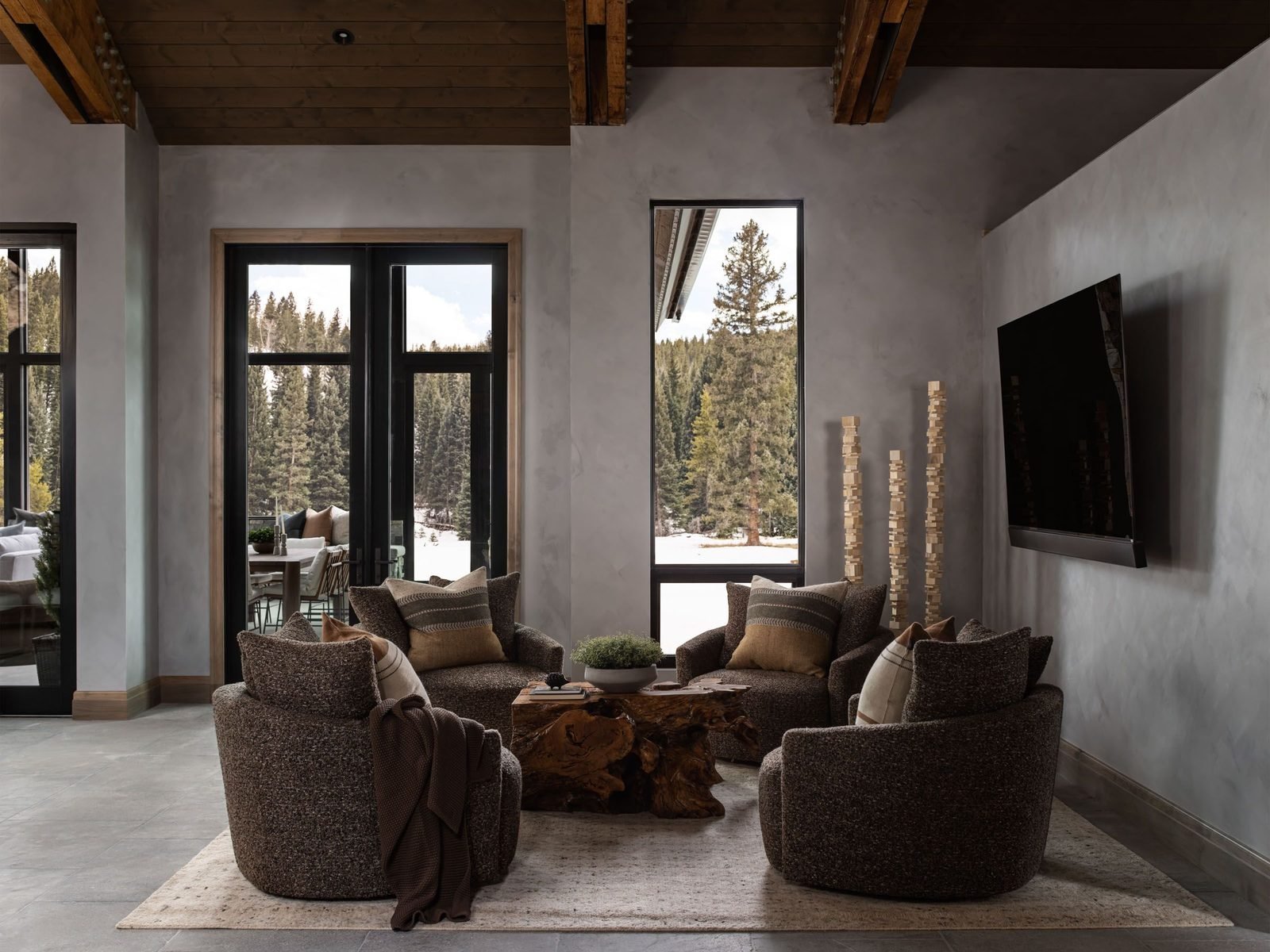 Boucle swivel chairs around a live-edge coffee table